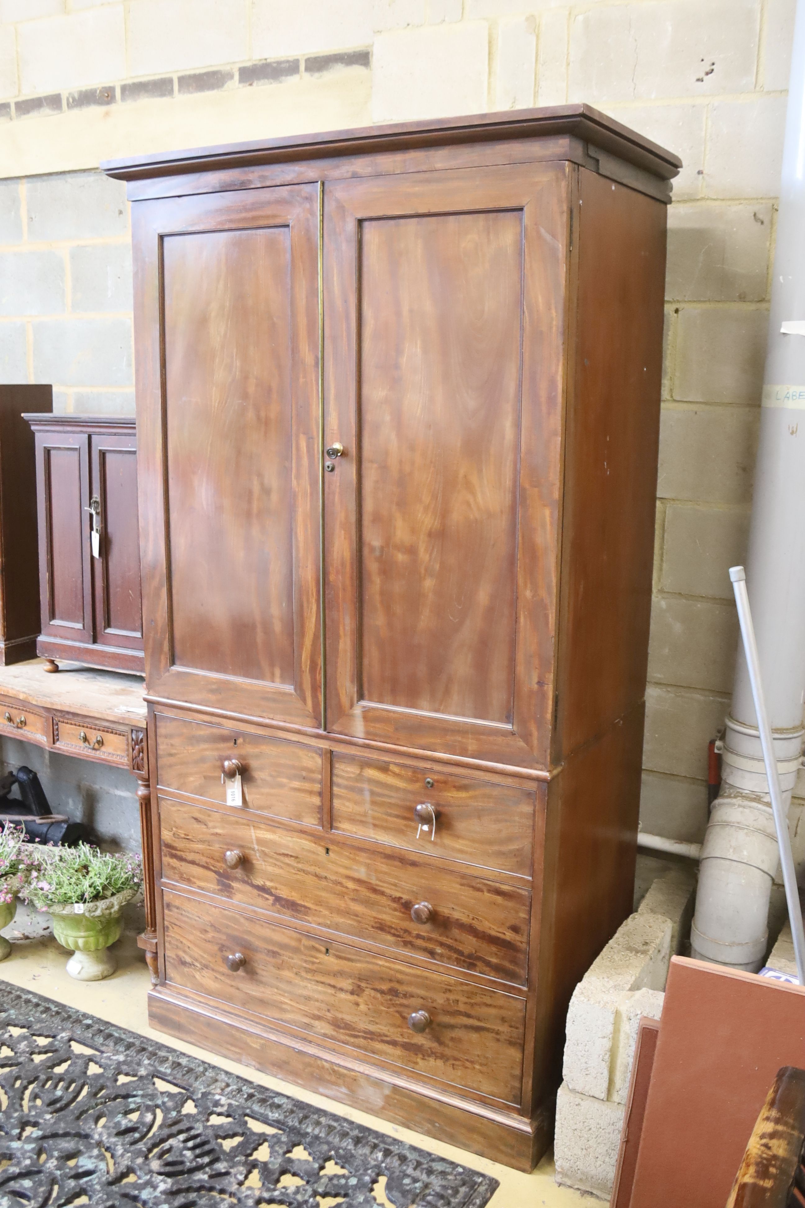 A Victorian mahogany linen press, formerly part of a larger wardrobe, width 112cm. depth 66cm. height 212cm.